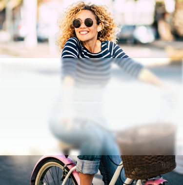 Banner image of happy lady moving freely, riding a bike